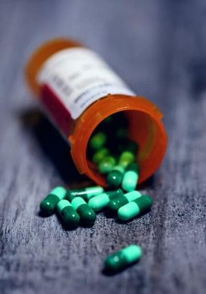 A pill bottle with pills spilling out.